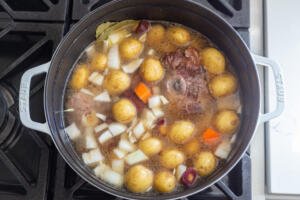 Oxtail with veggies in a pot with liquid