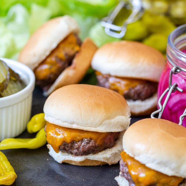 A pile of sliders with pickled veggies