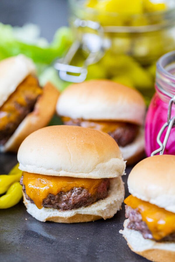 A pile of sliders with pickled veggies