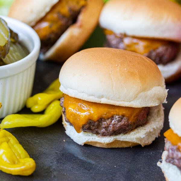 A pile of sliders with pickled veggies