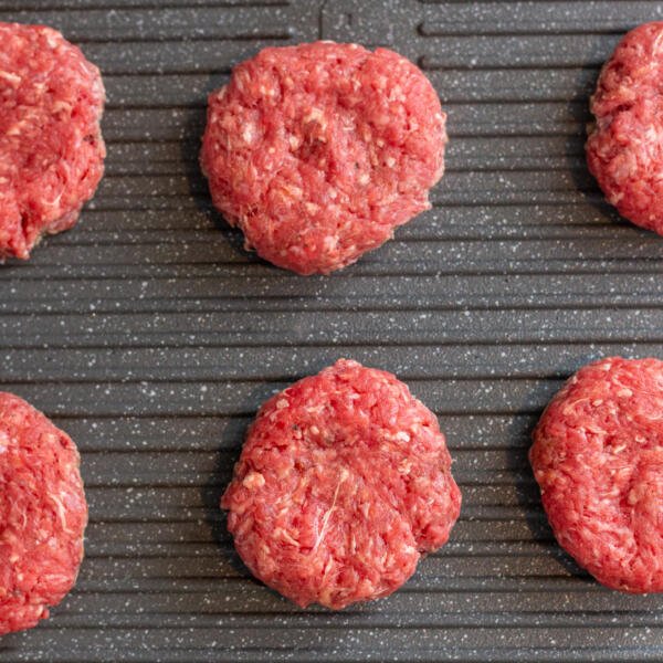Meat patties on a grill