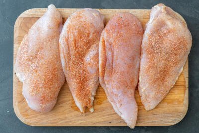 seasoned chicken breast on a cutting board