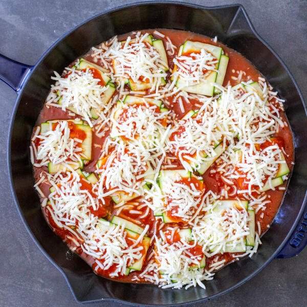 pan with zucchini ravioli and cheese on top