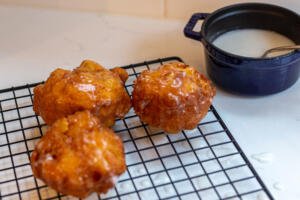Apple Fritters on a cooling rack with glaze