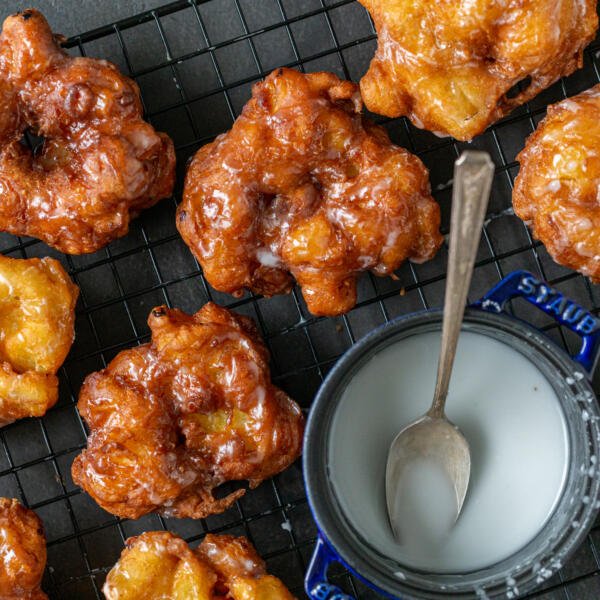 Apple Fritters on a cooling rack with glaze