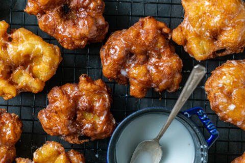 Apple Fritters on a cooling rack with glaze