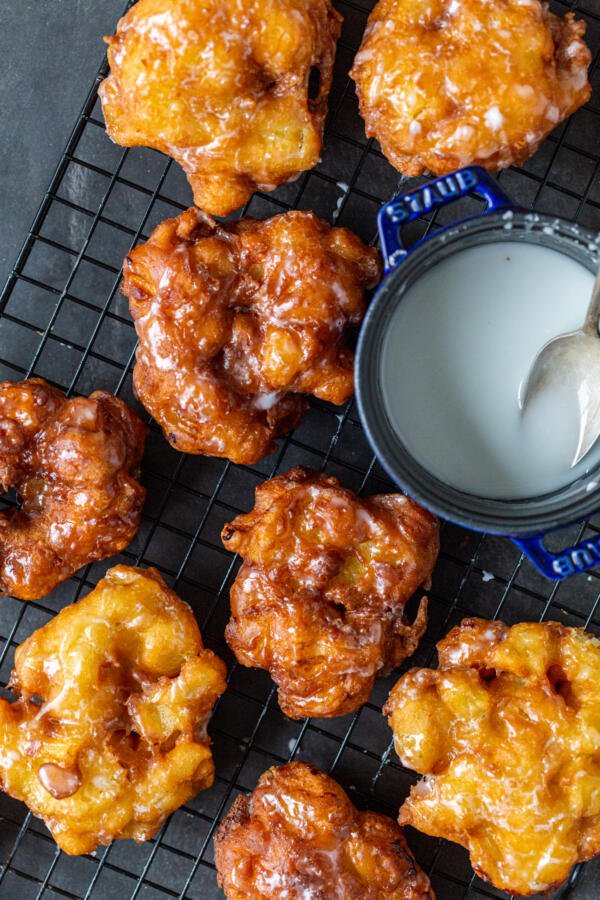 Apple Fritters on a cooling rack with glaze 