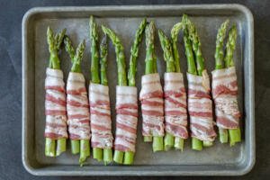 raw asparagus wrapped with bacon