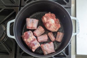 Oxtail browning in a pot