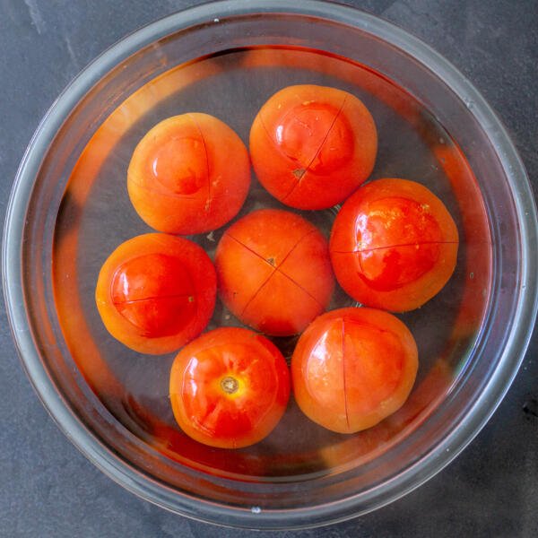 Tomatoes in a bowl with boiled water
