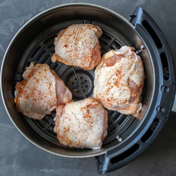Chicken Thighs in an air fryer basket