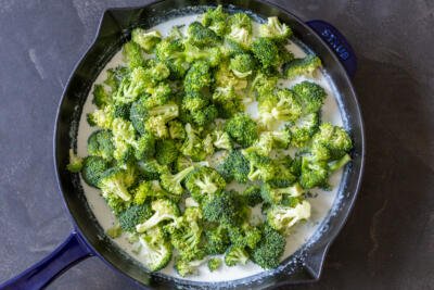 broccoli with alfredo in a pan