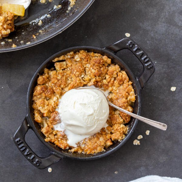 Apple crisp in a pan with ice cream