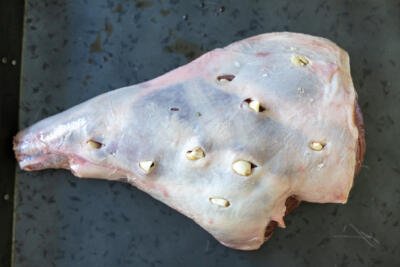 Leg of lamb with garlic pieces stuffed inside