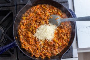 Beef Bolognese in a pan with parmesan cheese