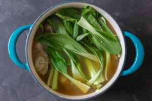 Bok choy in a pot with broth