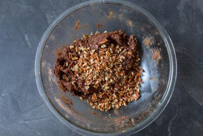 chocolate salami mixture in a bowl with nuts