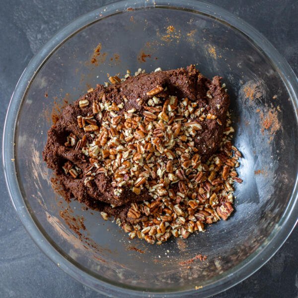 chocolate salami mixture in a bowl with nuts