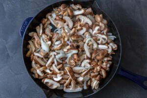 Shitake mushrooms with onion in a pan