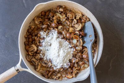 mushrooms in a pan with flour