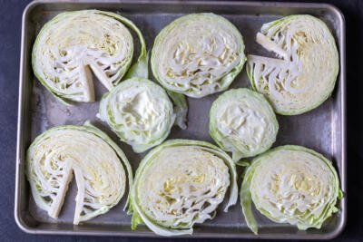 cut cabbage into pieces on a pan