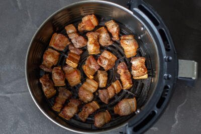 cooked Pork belly bites in an air fryer basket