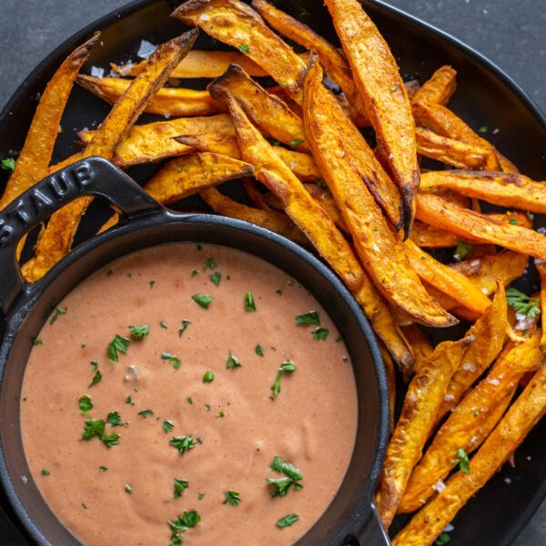 Sweet potato fries on a plate with sauce