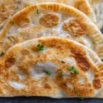 Chebureki with herbs on a counter