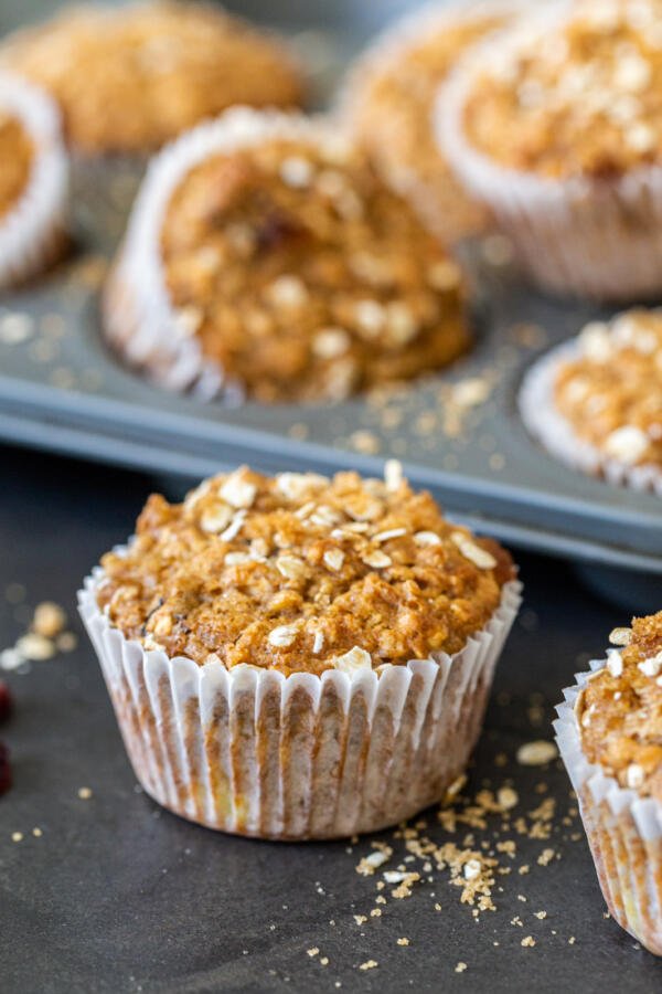 muffin in front of a mold with more in the background