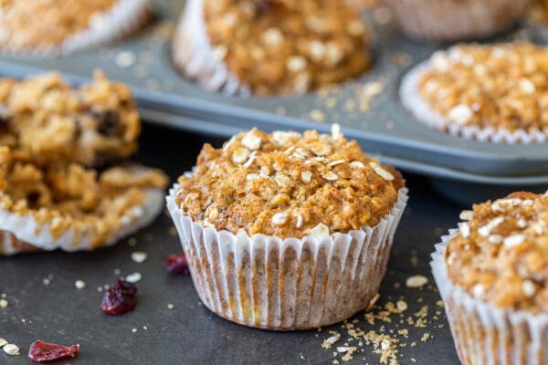 muffin in front of a mold with more in the background