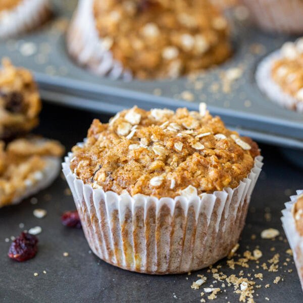 muffin in front of a mold with more in the background