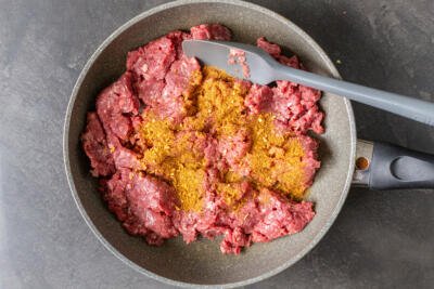 ground beef in a pan with taco seasoning