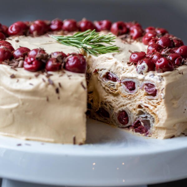 Honeycomb Cherry Cake on a cake stand cut open