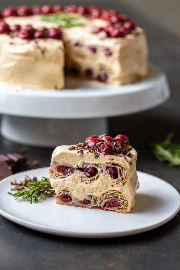 A slice of Honeycomb Cherry Cake on a cake stand 
