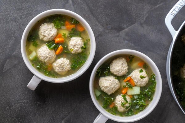 Two bowls of kale meatball soup