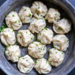 Khinkali in a seerving dish with herbs