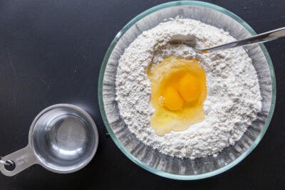 eggs added to the flour in a bowl