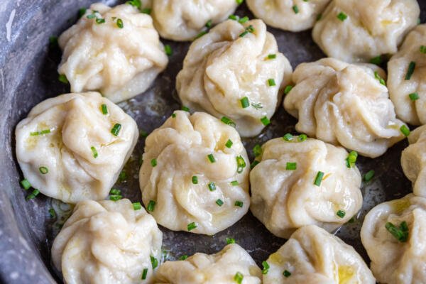 Khinkali in a seerving dish with herbs