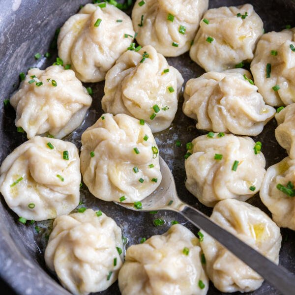 Khinkali in a seerving dish with herbs