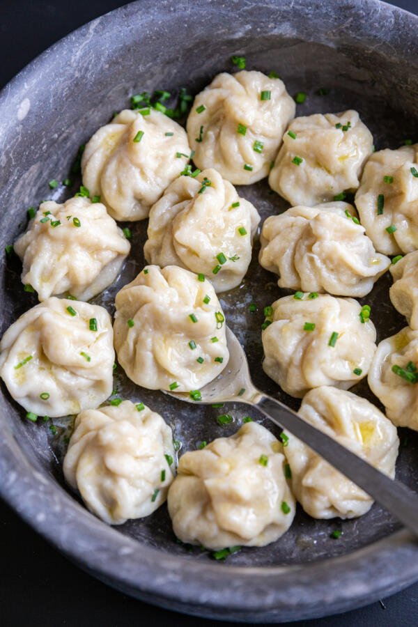 Khinkali in a seerving dish with herbs