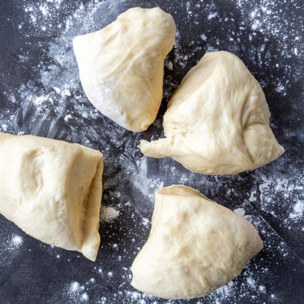 Challah Bread dough dived into four pieces