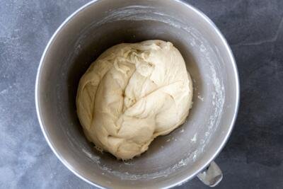 Kneaded dough is in Challah Bread dough in a bowl