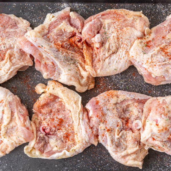 seasoned chicken thighs on a serving tray