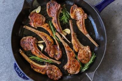 Lamb chops with garlic and herbs in a pan