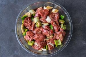 lamb marinating with veggies in a bowl