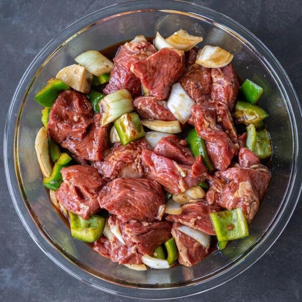 lamb marinating with veggies in a bowl