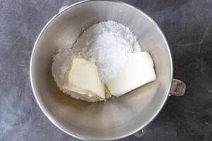 powdered sugar and cream cheese in a mixing bowl