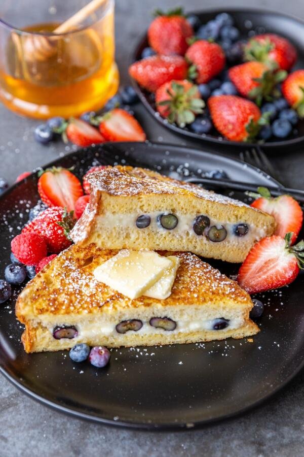Stuffed French toast on a plate with berries