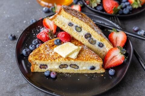 Stuffed French toast on a plate with berries