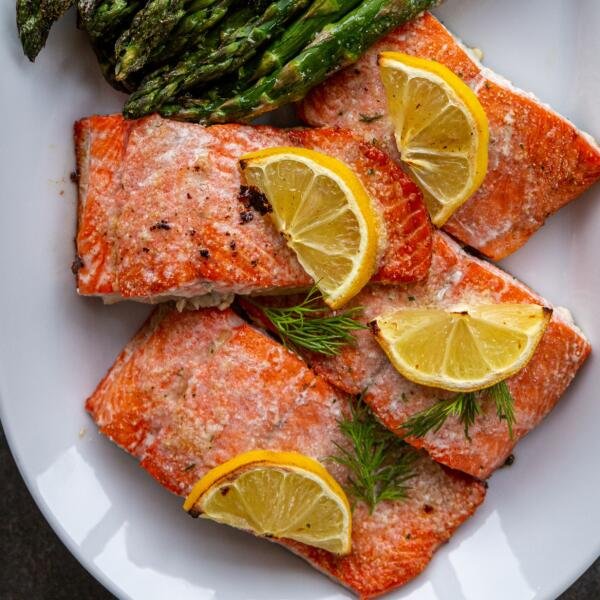 Baked salmon pieces with lemon on a plate